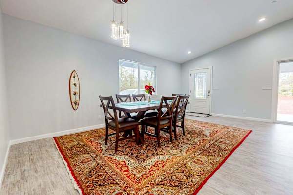 Large dining room table with seating for eight and lots of windows for that airy feel.