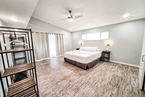 Large master bedroom with king bed and sliders to access the outside.