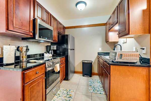 Well equipped kitchen with modern stainless steel appliances and new maple cabinetry.