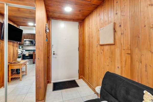 The interior is compact but thoughtfully designed, offering a sitting area with a TV, a bistro dining space, and a well-equipped kitchen with all-new stainless steel appliances and maple cabinetry.