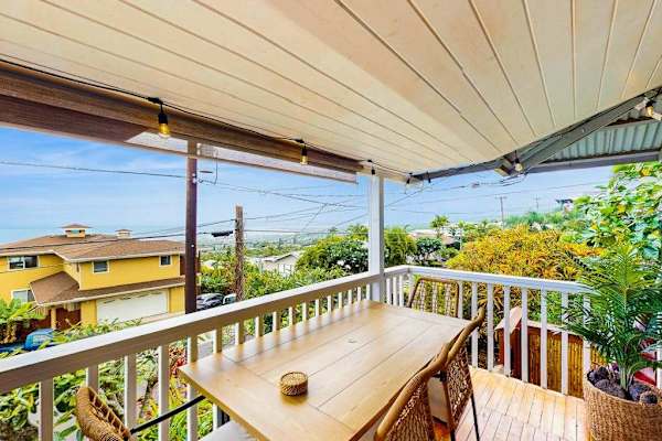 Covered balcony table offers open views and comfortable outdoor dining