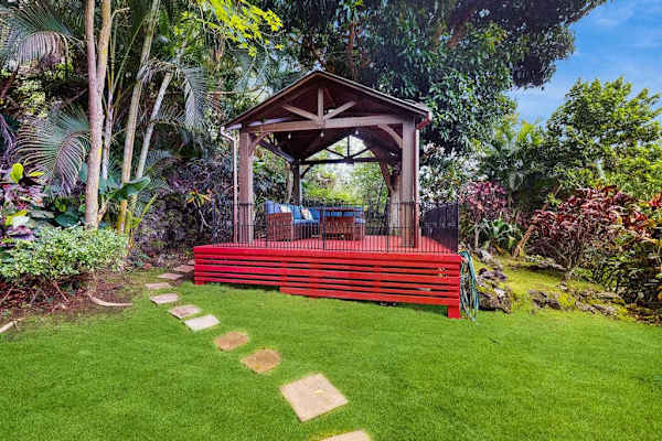 Garden gazebo offers shaded seating surrounded by landscaping and lawns