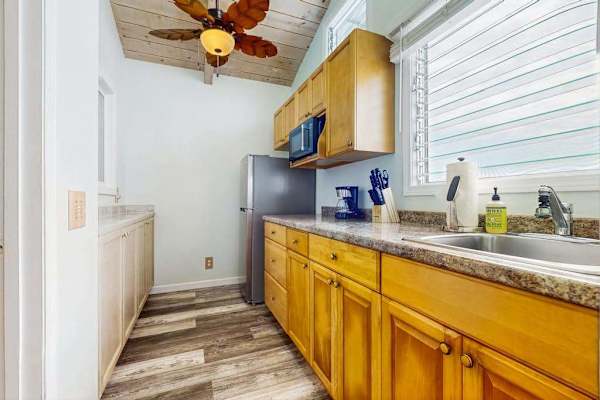 Kitchen offers wooden cabinetry countertop workspace and stainless appliances inside