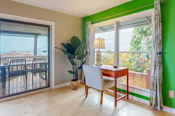 Breakfast nook opens to balcony with seating and garden views