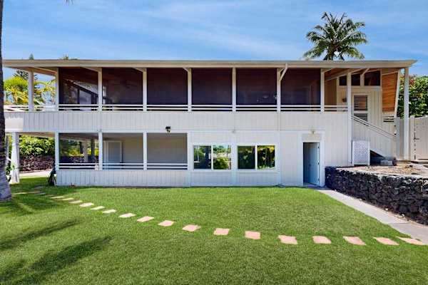 Two-Story Exterior with Upper Deck & Manicured Lawn