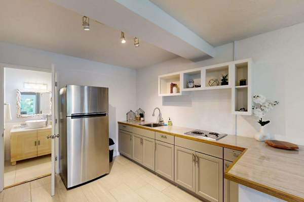 Well equipped kitchen features stainless appliances cabinetry and counter space