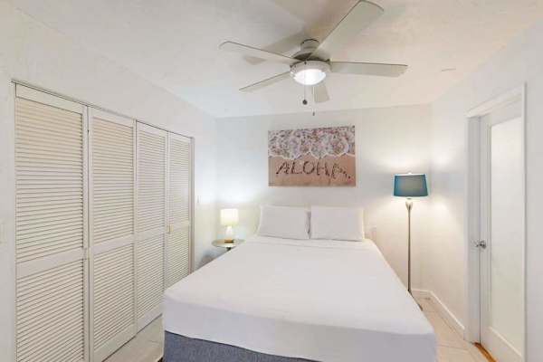First bedroom offers queen bed ceiling fan and natural light
