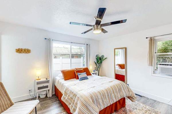 Master bedroom with queen bed and plenty of windows providing natural light.