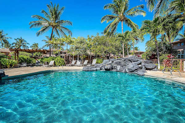 Tropical Oasis: Crystal-Clear Pool Framed By Rock Features