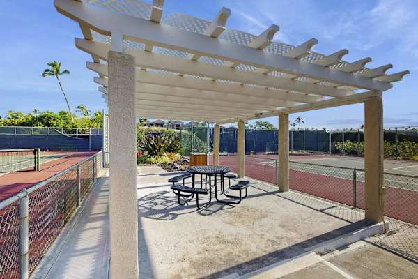 Relax in the shaded seating area just steps from the tennis courts.