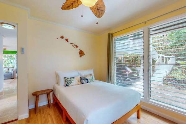 Second bedroom offers double bed bedside table and garden views