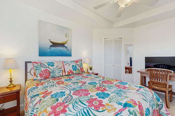 Master bedroom with queen bed with a flat screen tv.