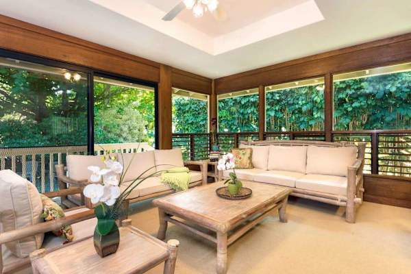 Bright living area offers sofas, artwork, windows, and wood details