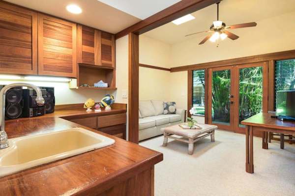 Open living space connects practical furnishings with a covered patio
