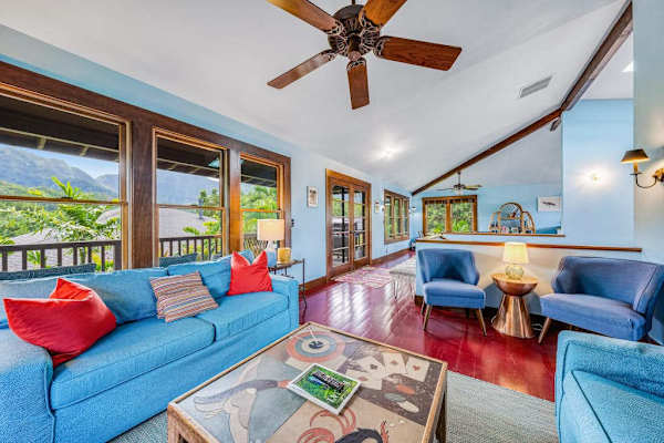 Bright living room showcases colorful seating, artwork, and panoramic windows