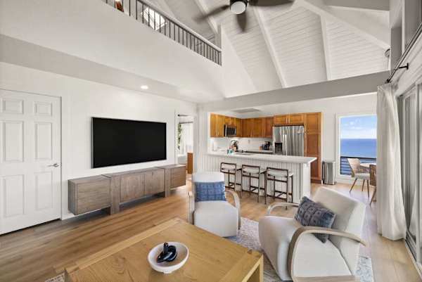Bright living room with ocean views and a large TV