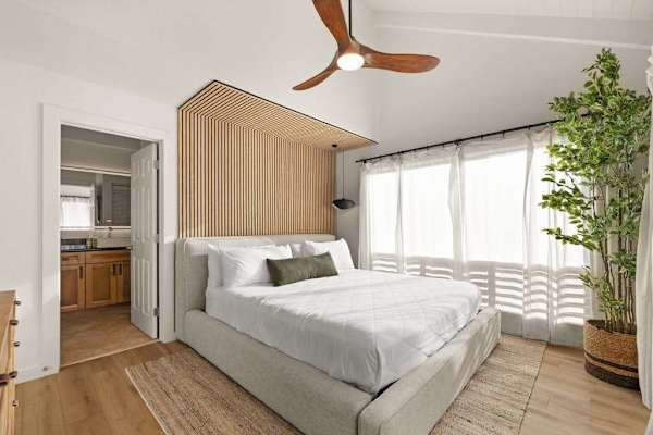 Cozy bedroom with large windows and abundant natural light