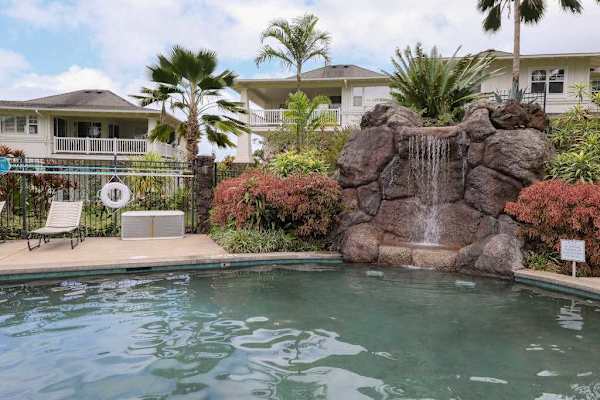 Resort-Style Swimming Pool with Waterfall Feature & Sun Loungers