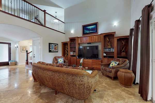 Large open-concept living room with a flat screen tv open to the upstairs.