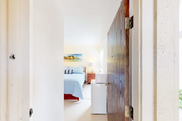Guest room with queen bed, flat screen tv and lanai access.