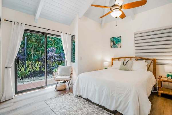 Guest bedroom with queen bed and lanai access.