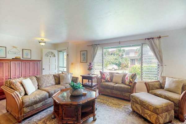 Large living room with plenty of comfortable seating for movie nights.