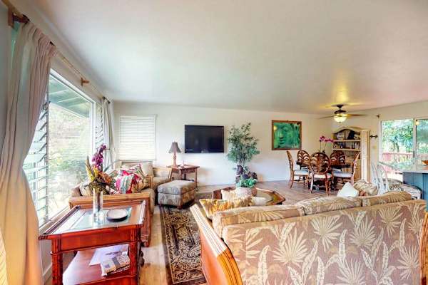 Large living room with plenty of comfortable seating and a flat screen tv for movie nights.