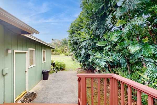 Step outside to the wraparound lanai, where lush tropical foliage creates a peaceful backdrop for morning coffee or evening conversation.
