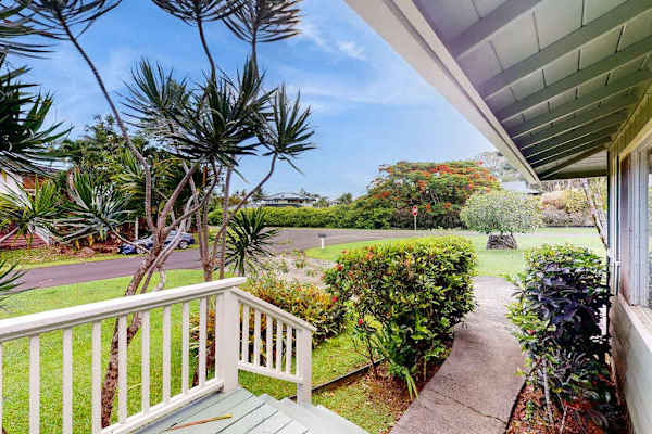 Lush tropical foliage surrounds this lovely home.