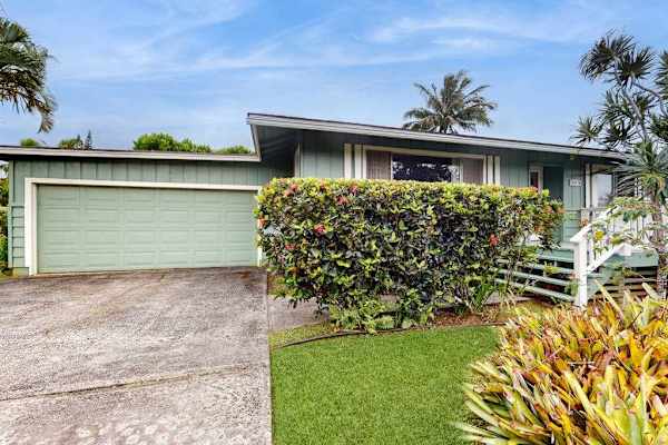 Lush tropical foliage surrounds this lovely home.