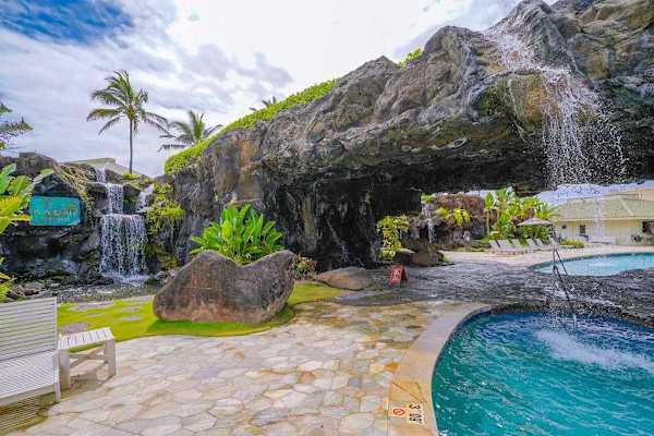 Tropical Waterfall Pool With A Serene Island Retreat
