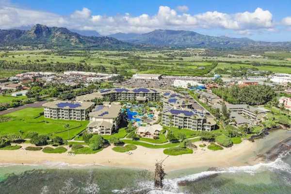 High-Angle Aerial View of Beachfront Resort & Mountains