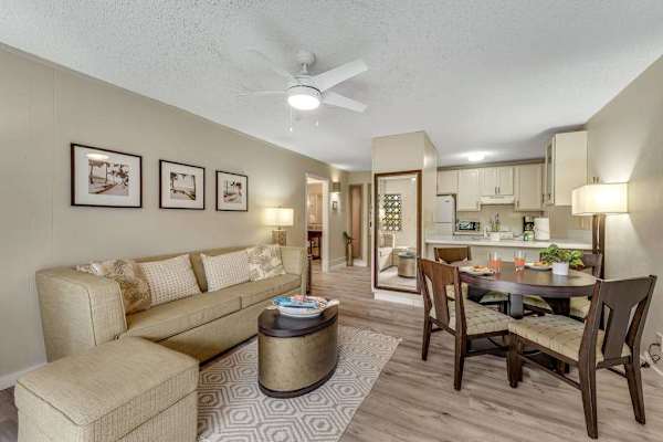 Open-Concept Living and Dining Space with Sofa, Ottoman, and Round Dining Table