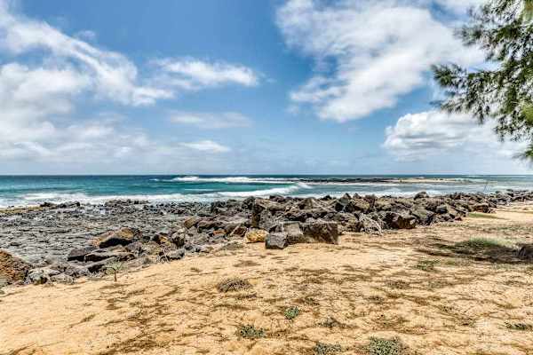Sandy Beachfront with Rocky Shoreline and Ocean Views