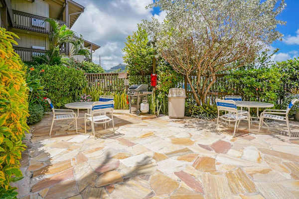Peaceful outdoor patio surrounded by tropical greenery
