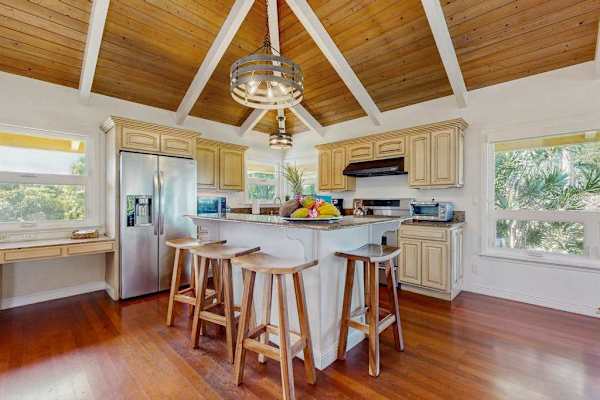  The kitchen is equipped with plenty of equipment to cook delicious meals, as well as luxuries like a kitchen island and a brand new stainless steel French door refrigerator. 