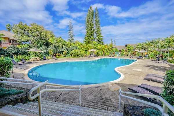 Sparkling resort-style pool surrounded by lush landscaping