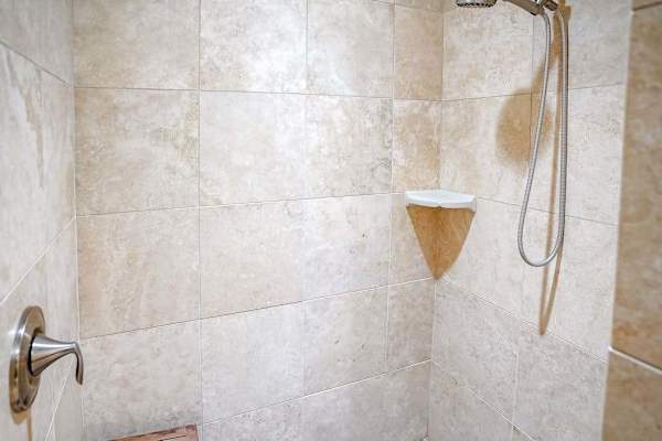 Master shower with spacious walk-in tiled shower.