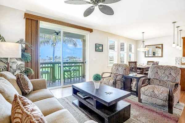 
Spacious living room with comfortable seating, flat screen tv and natural light streaming in from the private lanai.