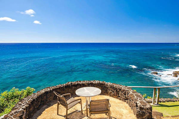 From your oceanfront perch on a lava-rock cliff, a dazzling ombre of blues tantalizes the eyes and the smell of saltwater tickles your nose. Let the ocean breezes warm you as you lounge on multiple lanais, listening to the waves crash below. 
