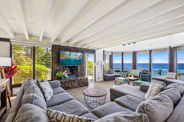 Spacious living room with panoramic views thanks to all of the glorious windows.