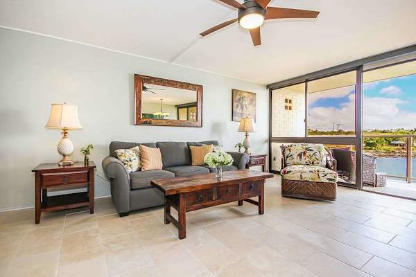 Floor-to-ceiling windows allow you to enjoy the ocean views from the living room, curled up on the couch, or oversized armchair. 