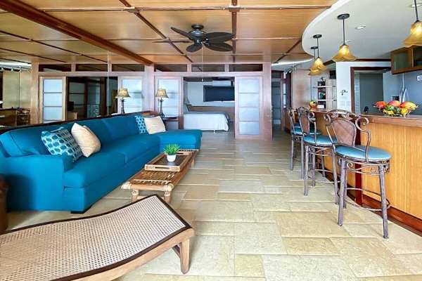 Living room comfortable seating, sofa bed, flat screen tv and views from the lanai.