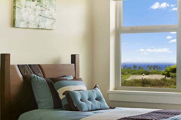 Guest room with two twin beds and flat screen TV.