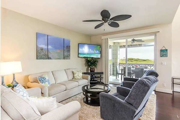  Settle into the bright living room, where you can put your feet up on the couch and two chairs to watch movies on the flatscreen TV. Extra guests? The couch doubles as a queen sleeper sofa. Large picture windows and sliding doors.