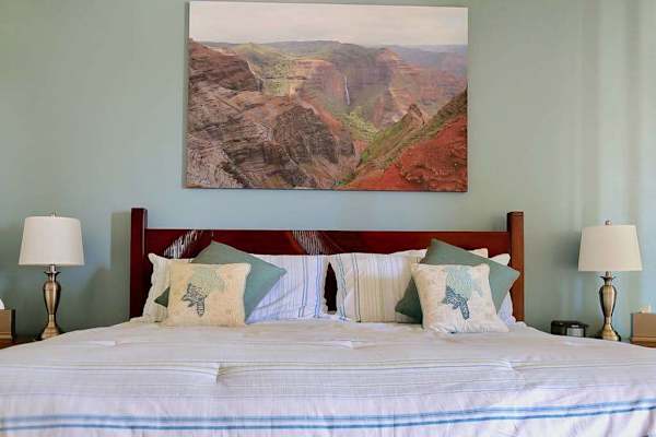 Guest room with king bed with flat screen tv.