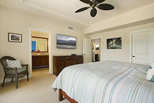 Calming main bedroom with a king bed, private lanai, flat screen tv and en suite bathroom. 