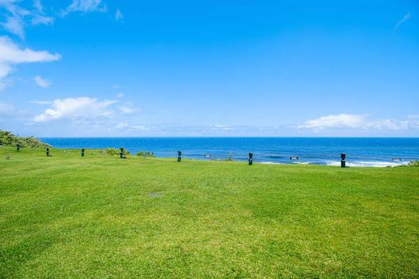 Enjoy panoramic ocean views from the lush lawn