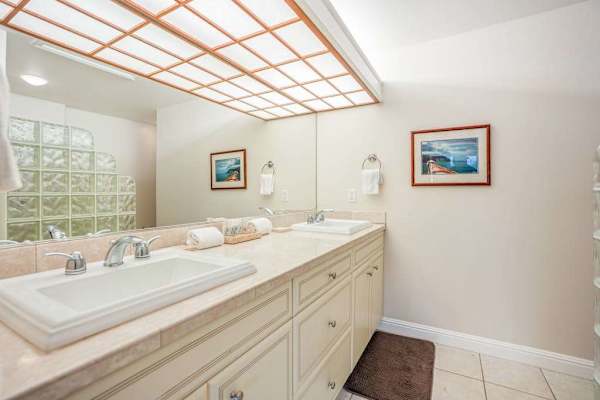 Guest ensuite bathroom with double sinks and a large walk-in shower.