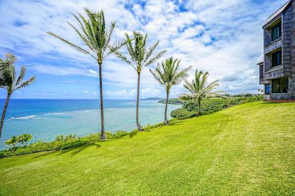 Expansive oceanfront lawn offering panoramic views of the coast and mountains